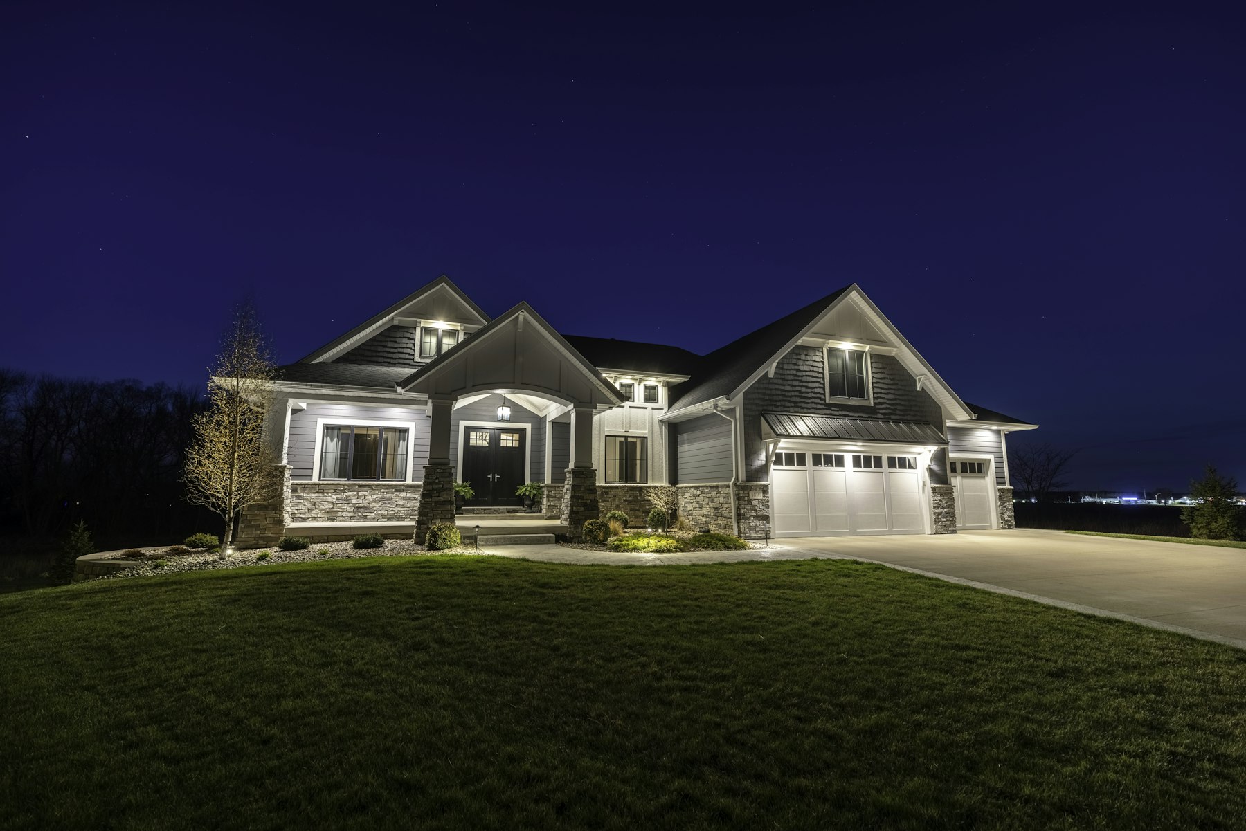 A craftsman-style Utah home glowing at twilight