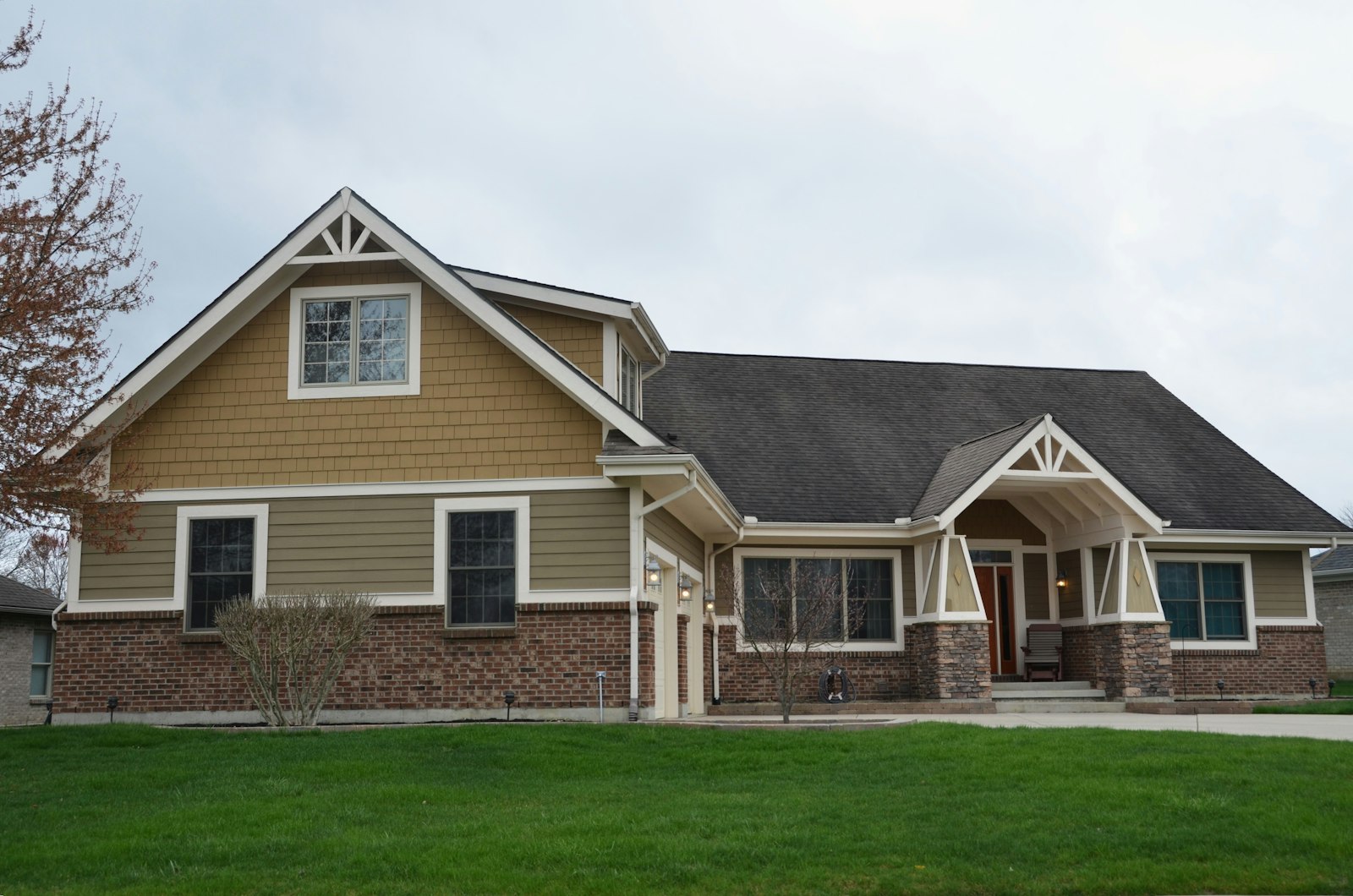A traditional craftsman-style suburban Utah family home with brick and tan siding